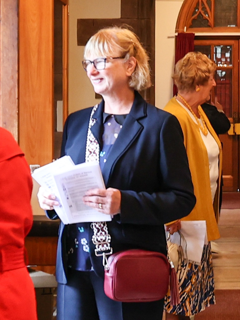 elder welcoming worshippers at church door